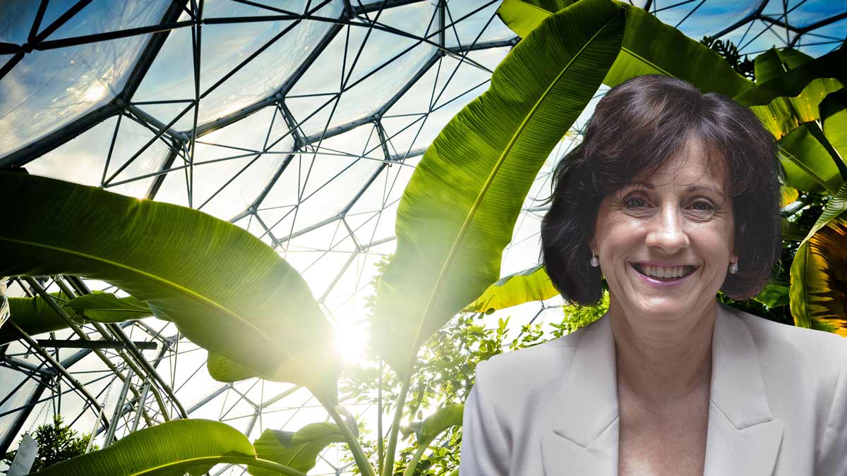 lesley hughes in front of a biodome with tropical plants