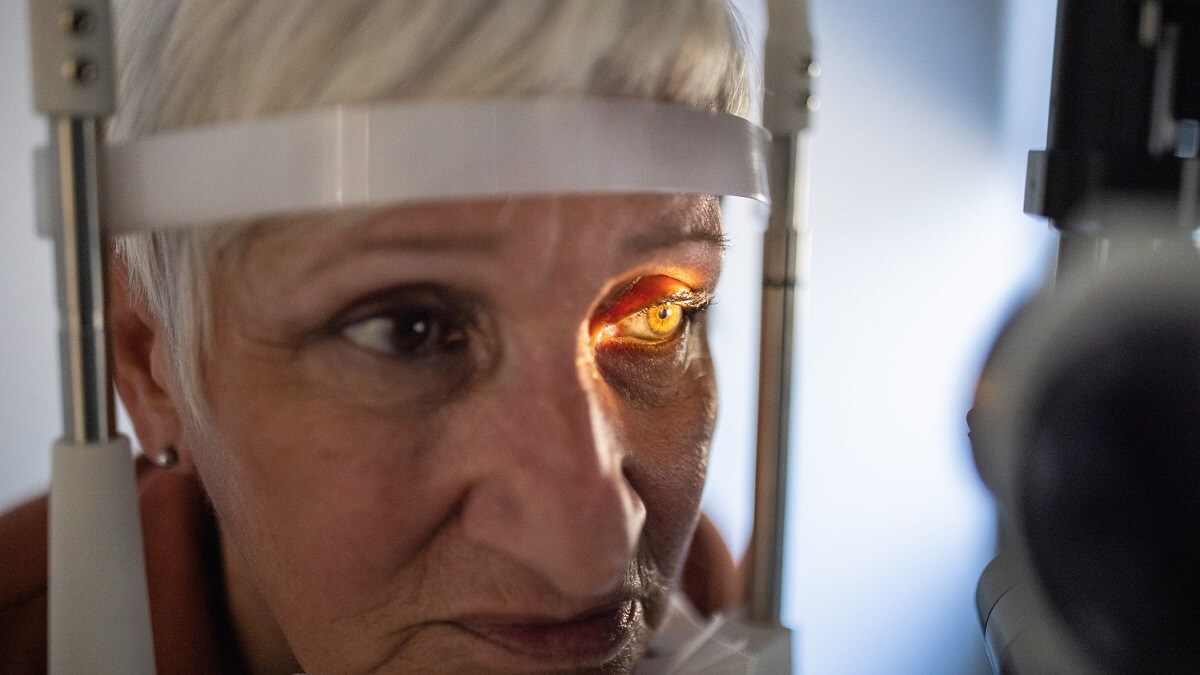 A senior woman undergoes an eye exam