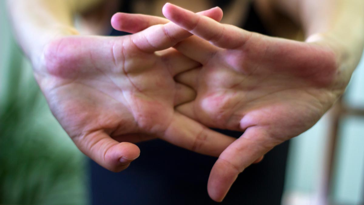 closeup of white woman stretching hands and cracking her knuckles
