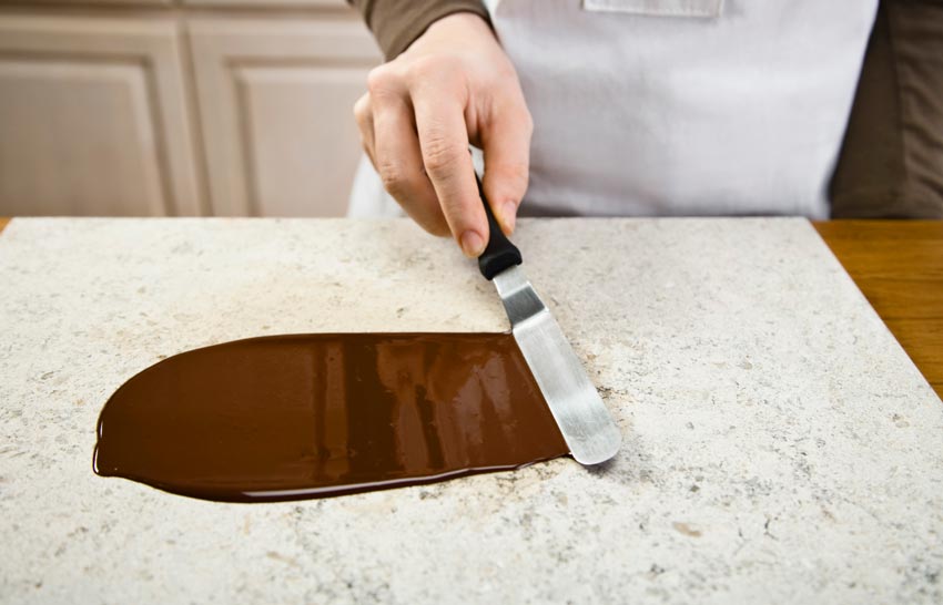 Tempering chocolate on a marble slab