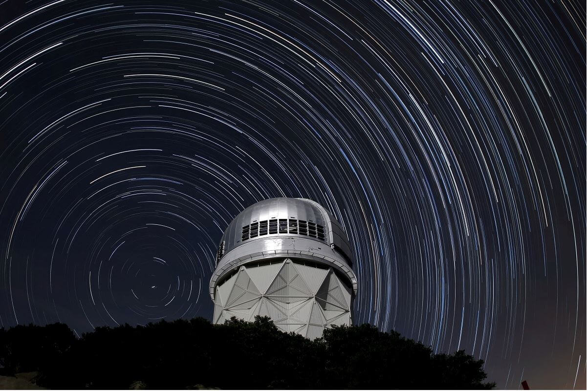 Telescope with star trails over the top