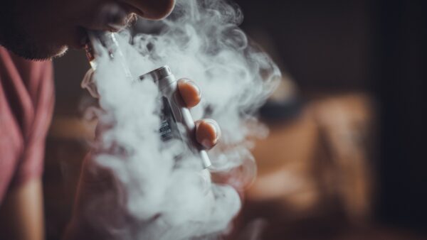 close up of person using e-cigarette