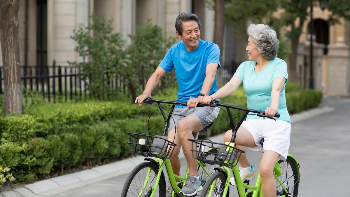 older couple riding bikes together