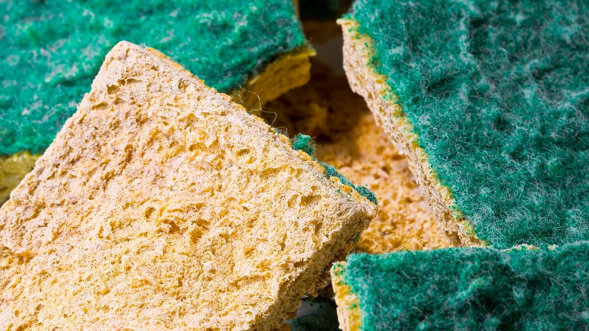 Yellow and green kitchen sponges in a pile