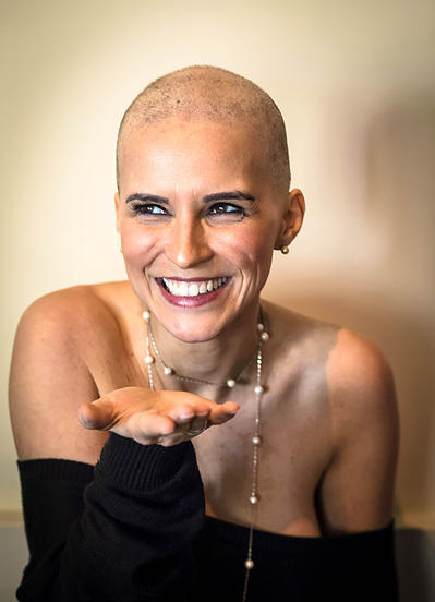 Portrait of a woman after cancer diagnosis bald from chemotherapy smiling