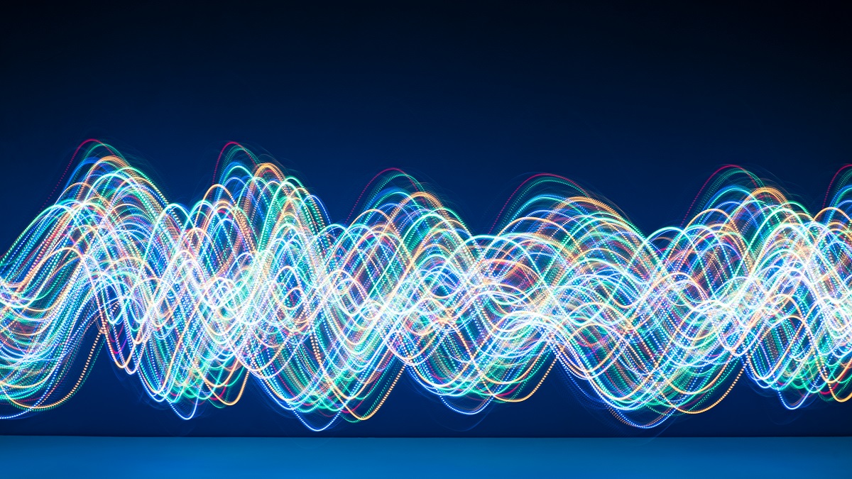 Brightly coloured sine waves against a dark blue background.