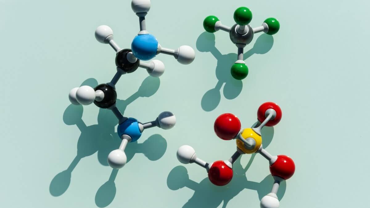 three plastic molecular models on a table