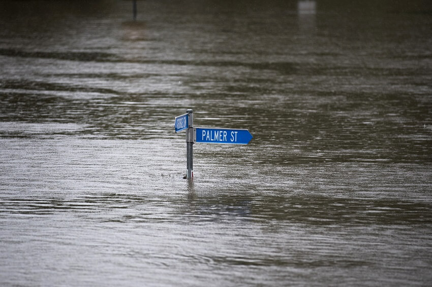 A street sign submerged by floodwaters