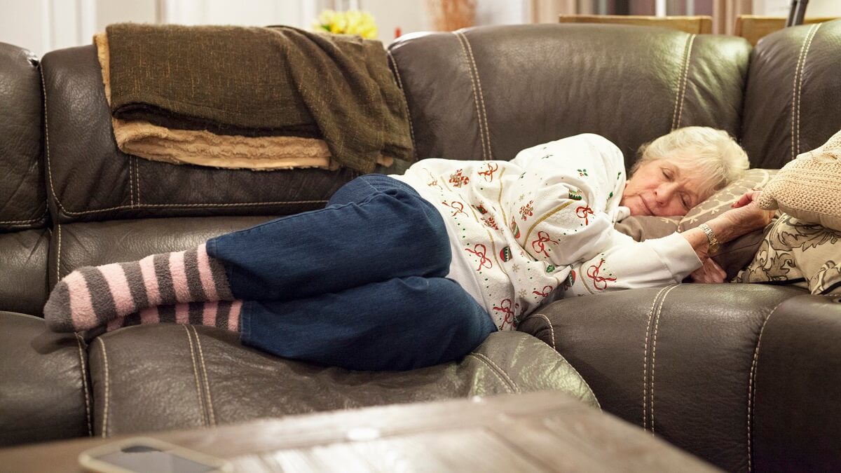 Alzheimer's dementia linked to excessive napping in elderly. An elderly woman naps on the couch.