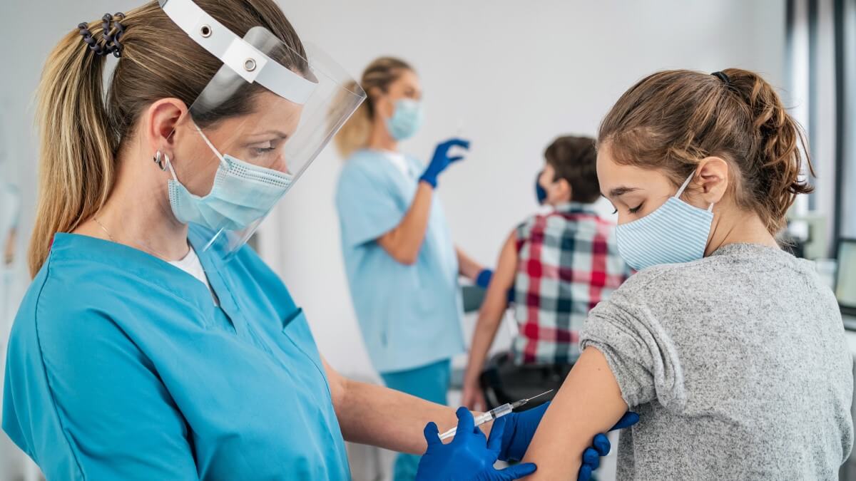 girl being vaccinated by doctor