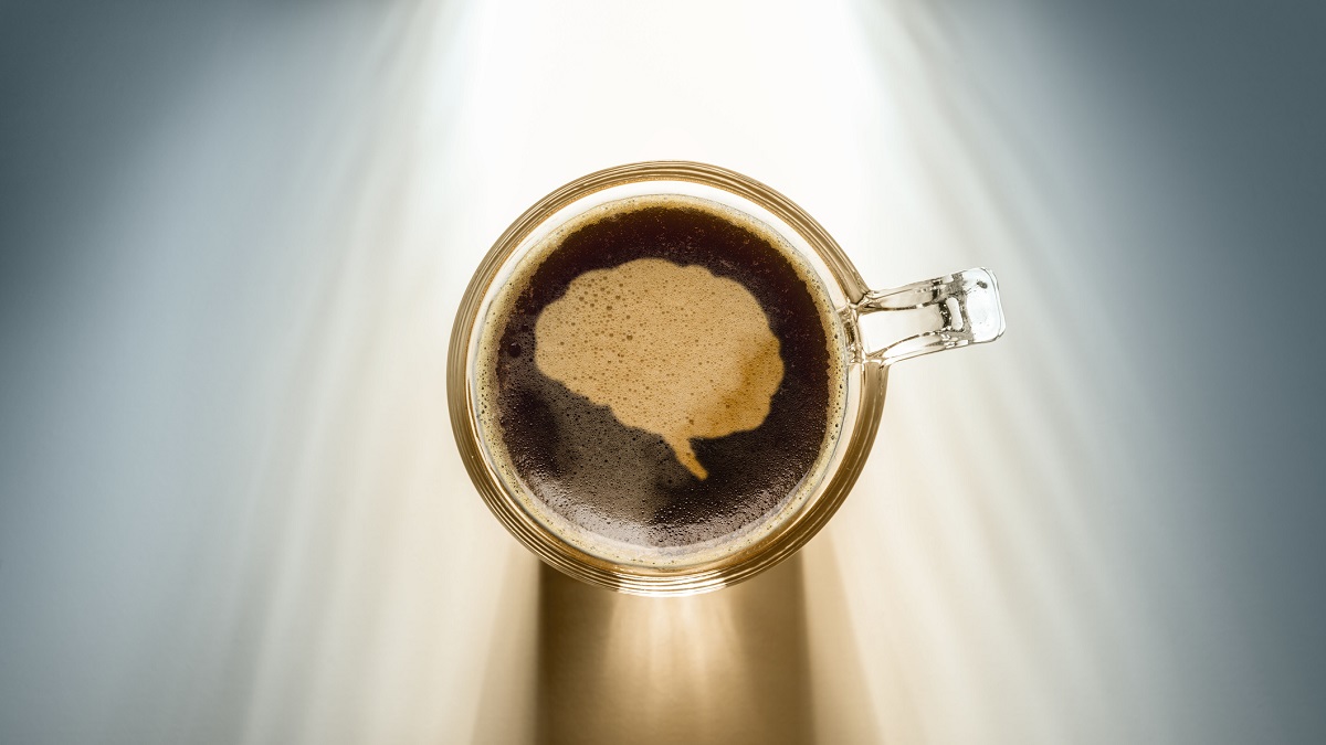 Cup of coffee with a brain in foam