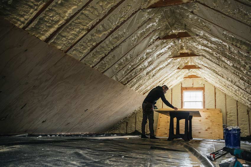 Health impacts of climate change concept a man installing insulation in a roof