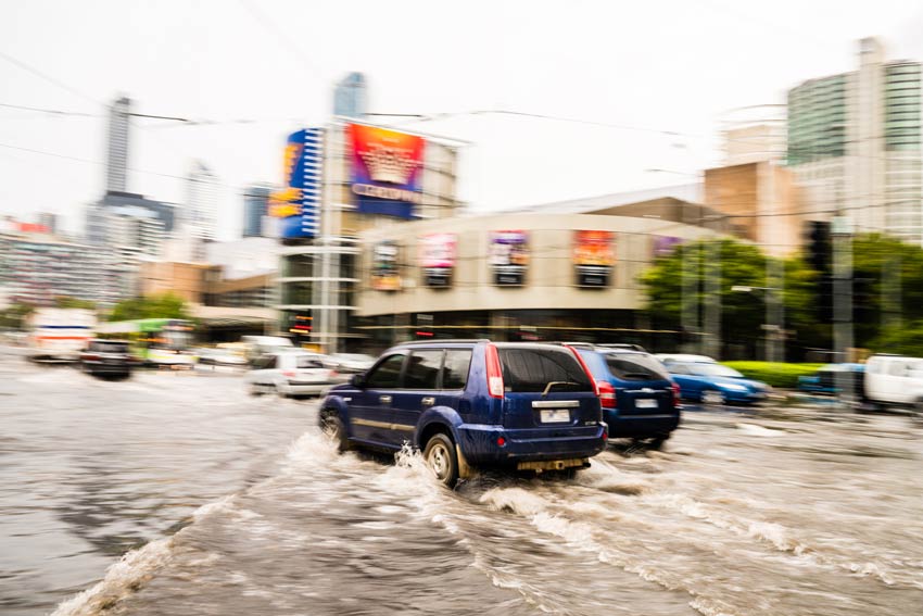 Health impacts of climate change concept cars driving on a flooded road in melbourne cbd