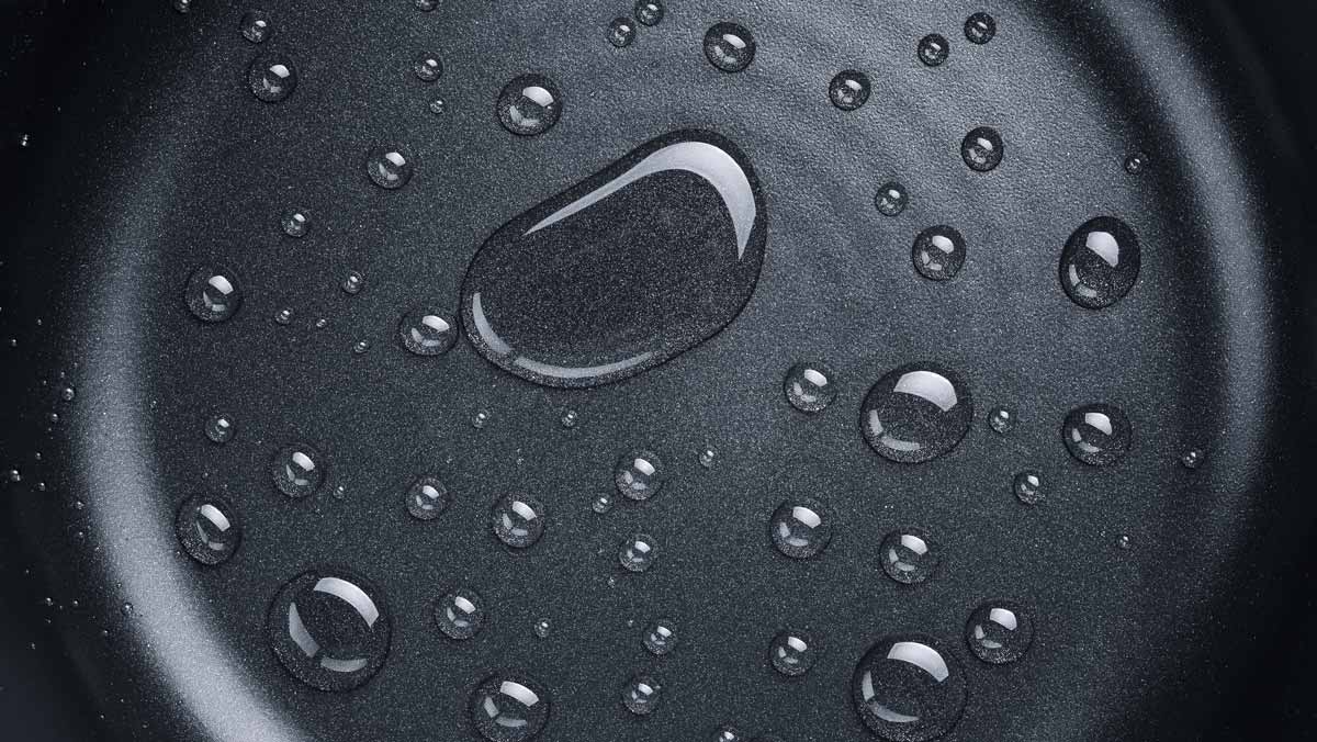 pfas concept photograph of water droplets on a nonstick pan