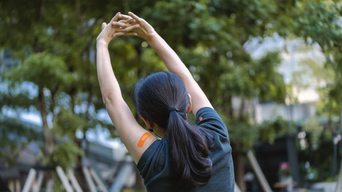 Woman exercising in park after receiving flu vaccination