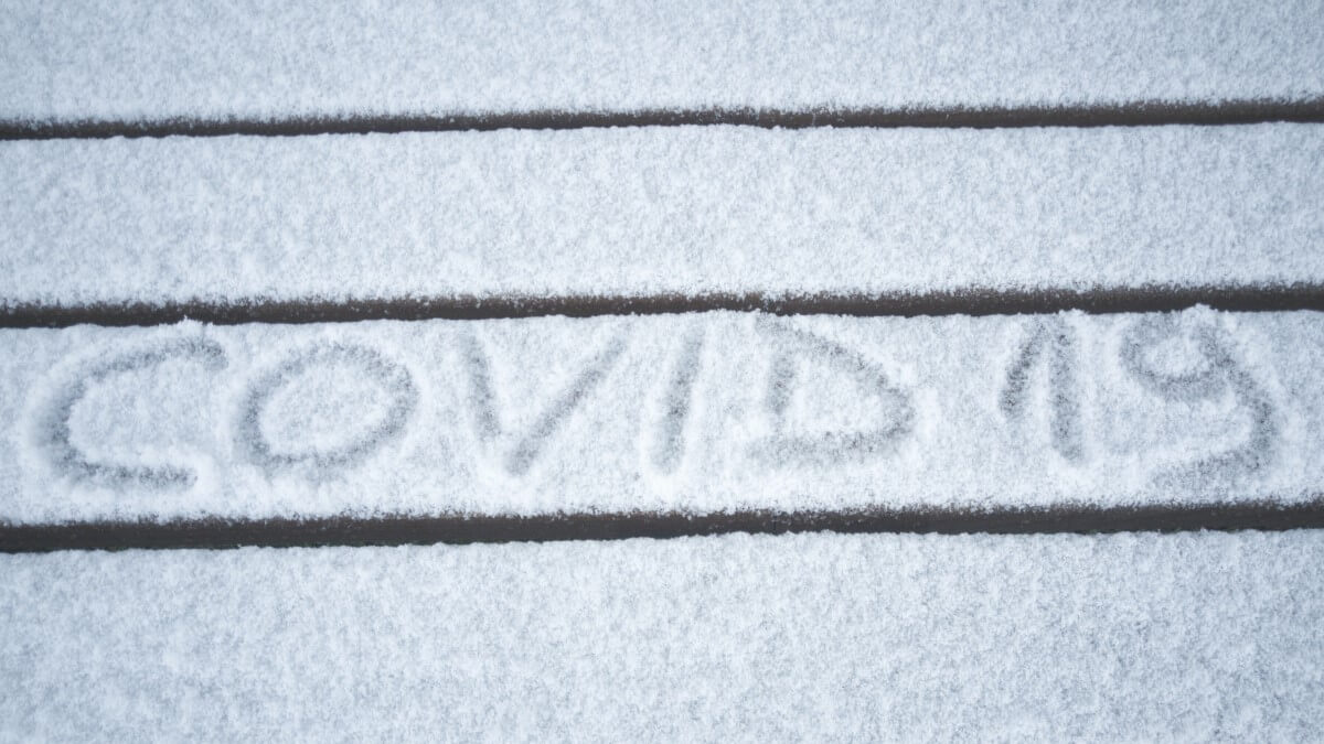 covid winter booster concept "covid-19" written in snow