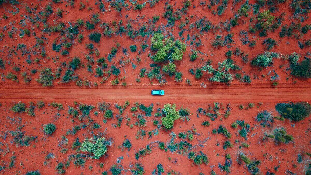 car driving through Australian outback - representing electric vehicles, EVs, in remote Australia