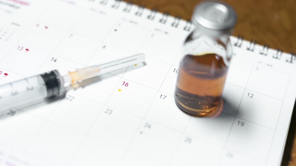 vaccine and calendar, representig menstruation or heavy periods after COVID-19 vaccination