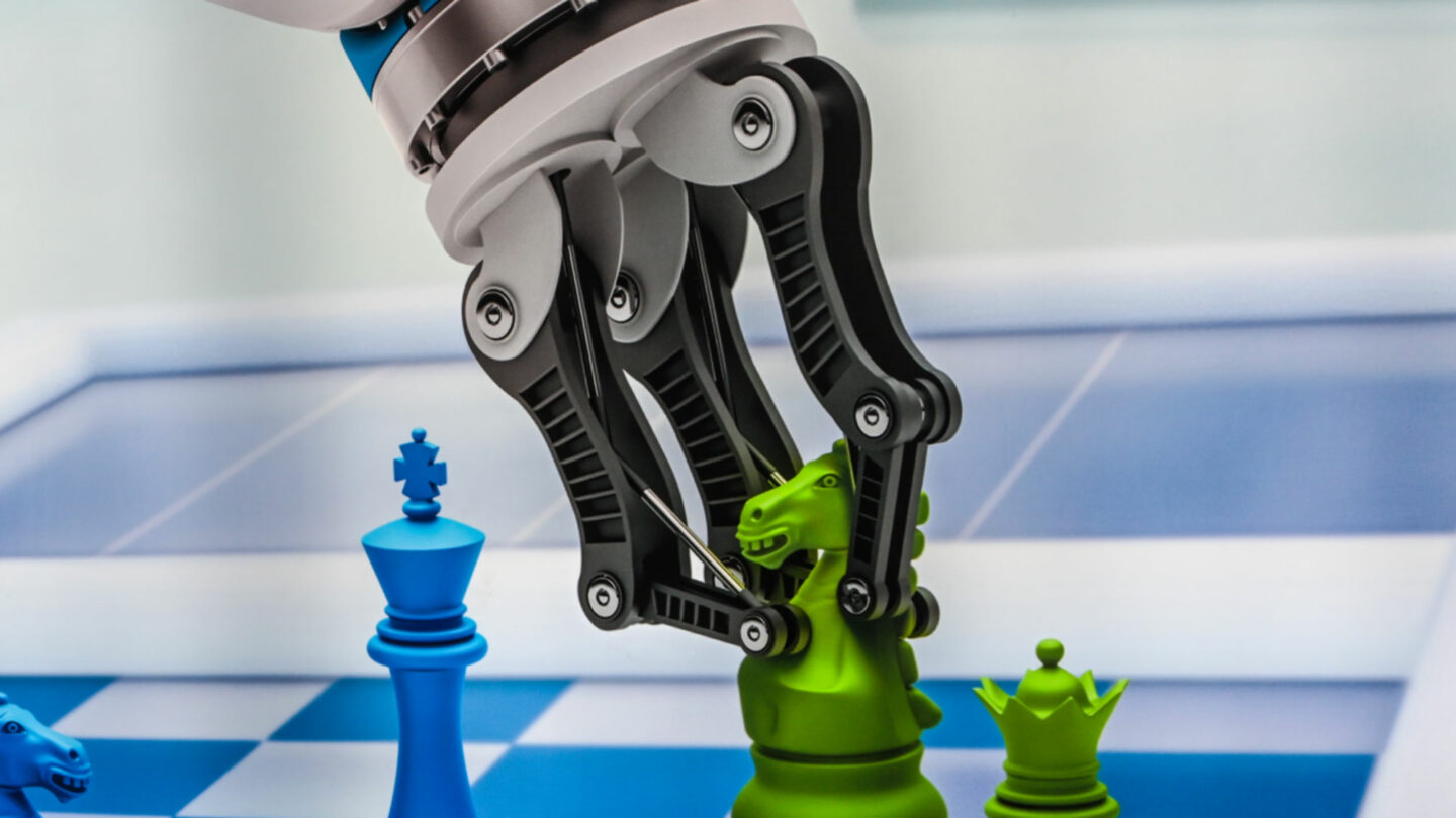 Image of claw grabbing chess piece from technology show