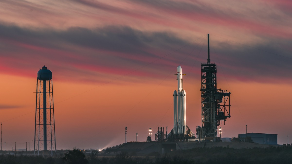 Space x falcon rocket pictured at a launchpad at sunset