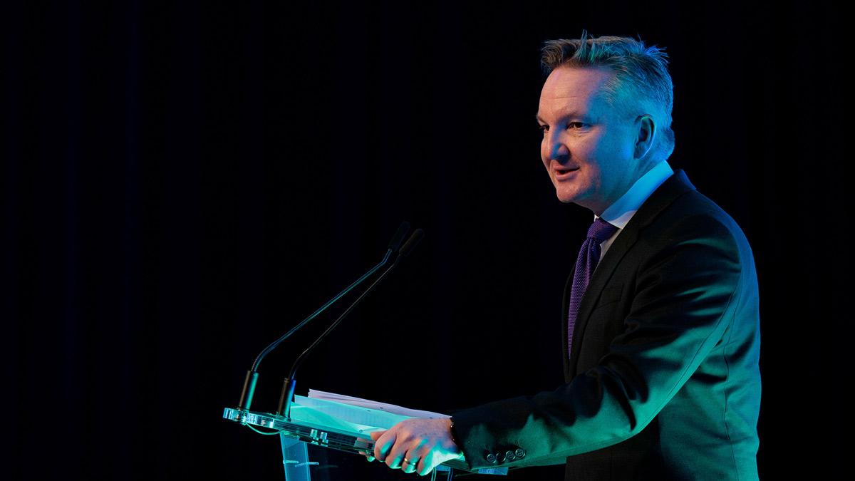 Australia's climate change minister chris bowen speaking at a lectern