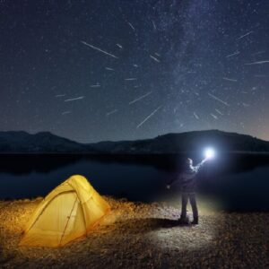 Perseid meteors viewed by a camper with a tent