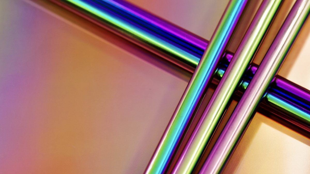 titanium alloy tubes in bright colours against a bright background