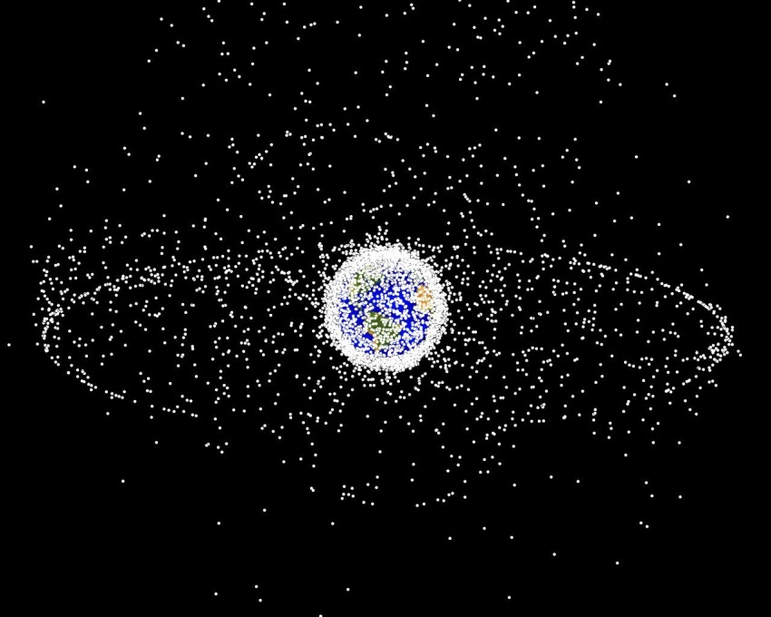 Earth surrounded with an orbit of hundreds of small white dots