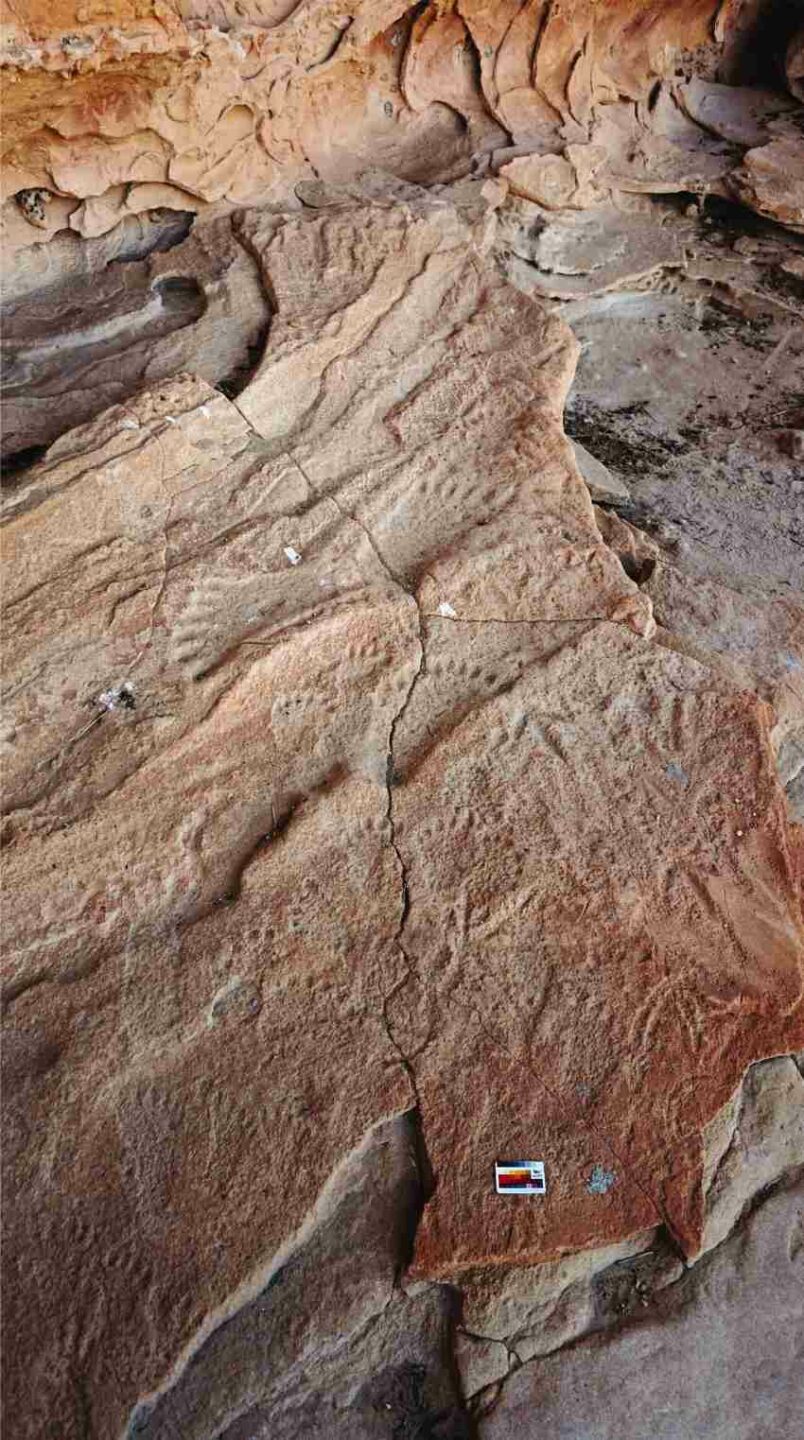 Photo of rock art depicting feet carved into the rock