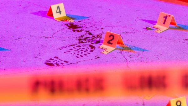 bloodstain pattern at crime scene with evidence marks and police tape