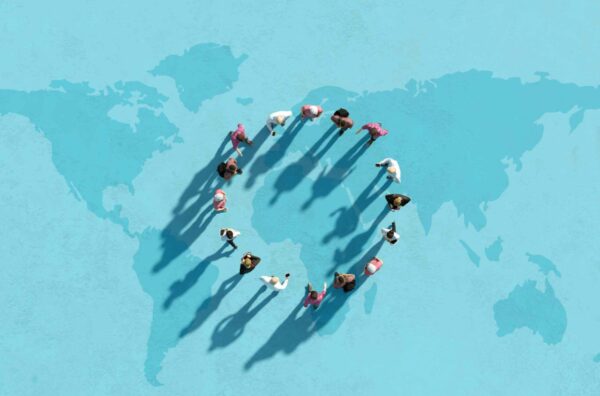 A group of people forming a circle on a world map.