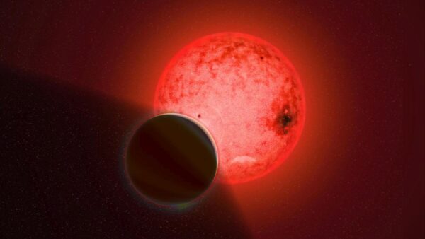 A gas giant in front of a red dwarf