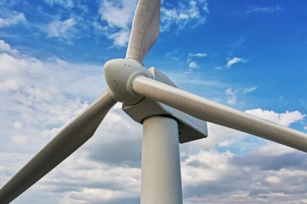 Wind turbine propellers with blue sky and clouds.