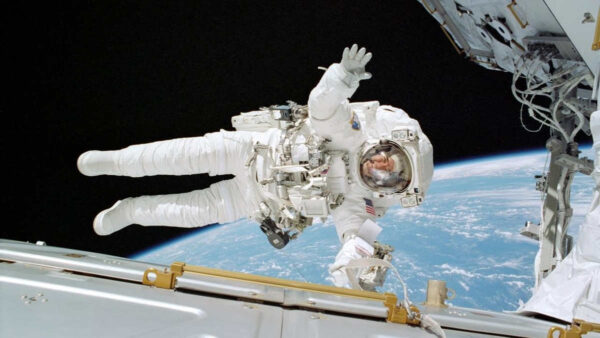 an astronaut in a space suit on a space walk at the international space station iss in earth orbit