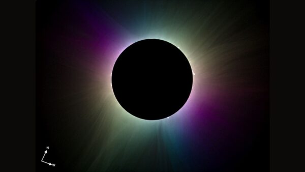 A photograph pf an eclipse showing the sun's corona in a rainbow of artificial colours