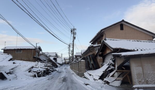 Noto Peninsula, Japan - January 14, 2024: A view of earthquake-affected buildings and roads buried under snow in Noto Peninsula, where many earthquakes occurred in early January and killed at least 232 people.